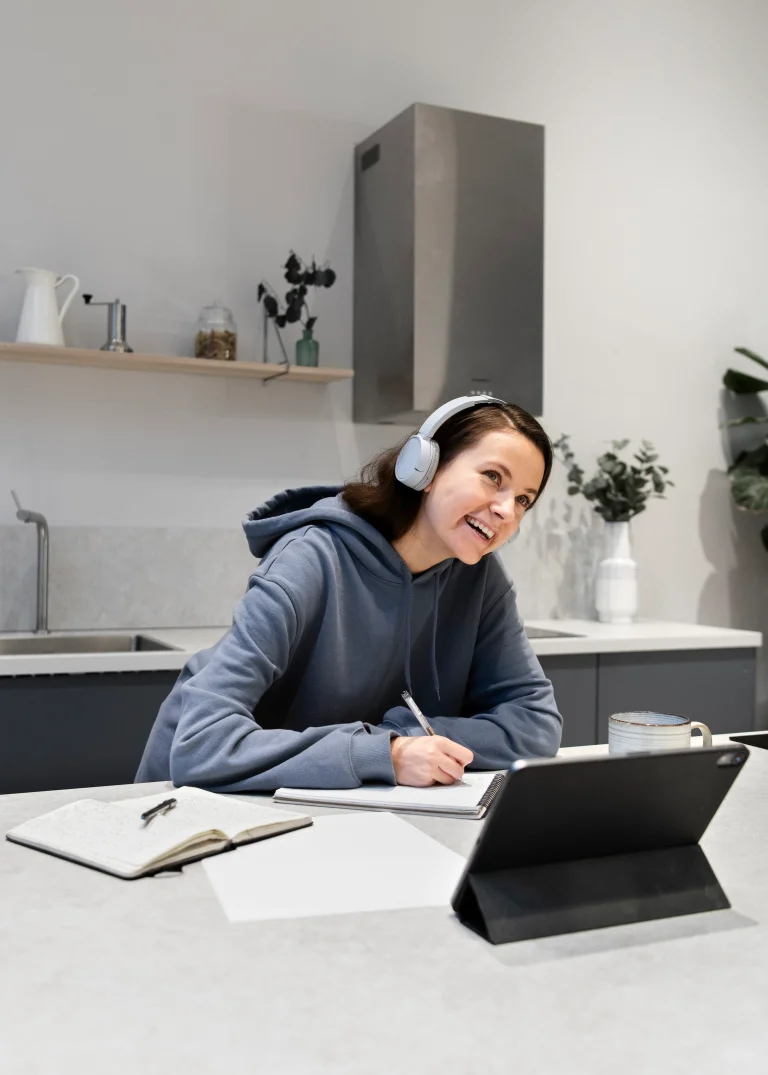 woman-working-from-home-kitchen-with-tablet